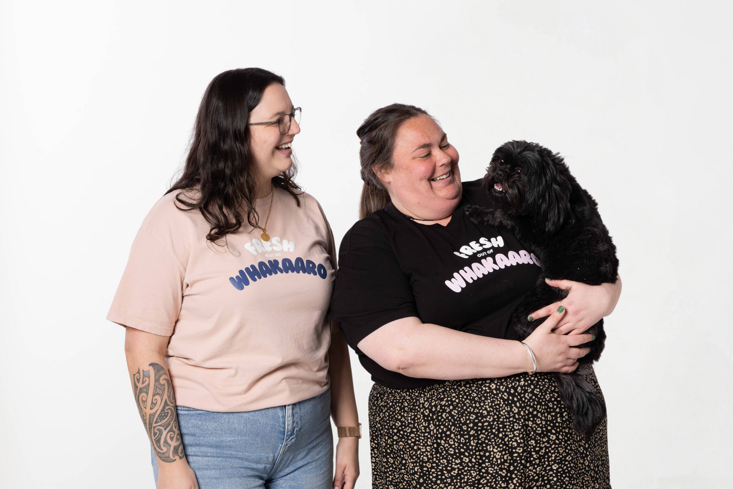 Models wearing the FRESH OUT OF WHAKAARO T-SHIRT – a unisex, 100% cotton tee from Choose Sarcasm’s Māori clothing collection.