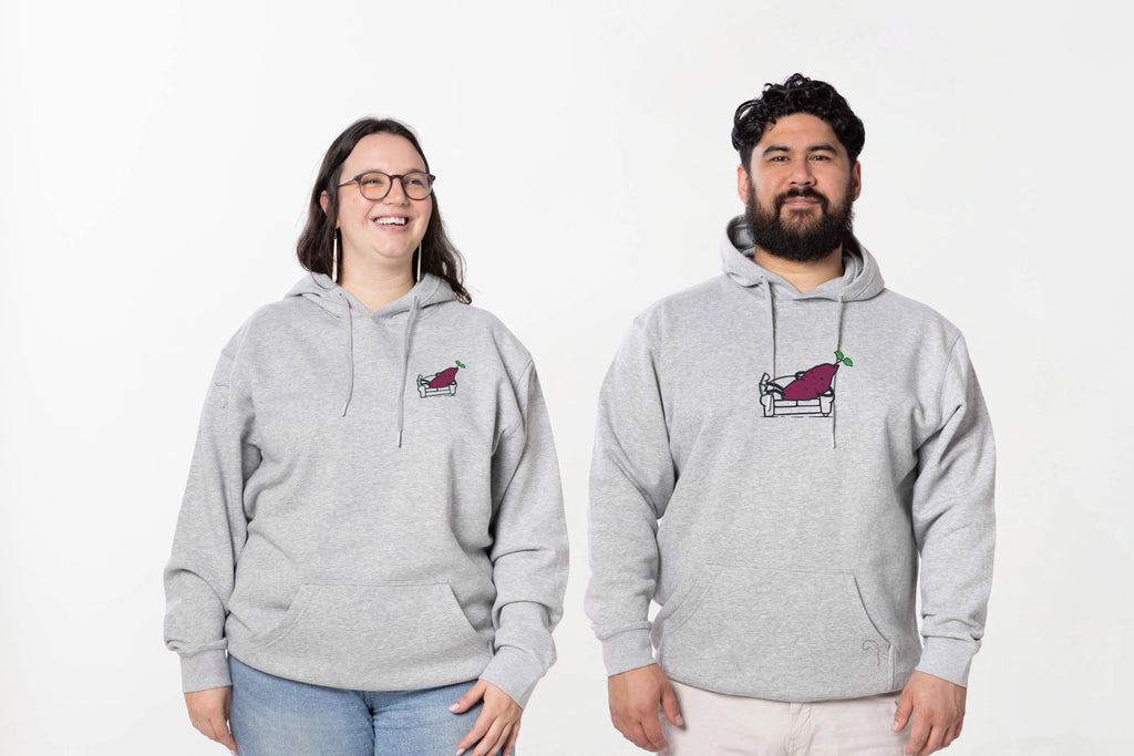 Models wearing the Couch Kūmara Hoodie – unisex, Māori-inspired cotton/polyester hoodie for everyday NZ wear.