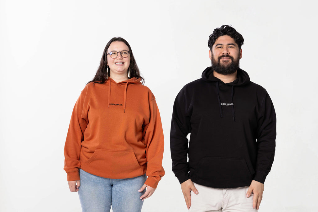 Models wearing the Hint of Sarcasm Hoodie – unisex, Māori-inspired cotton/polyester hoodie for everyday NZ wear.