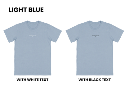Flat lay of the HINT OF SARCASM T-shirt in light blue with two options, one with black text and one with white text, part of our Māori men's and women's clothing NZ collection.