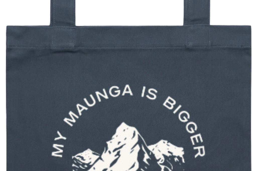 Flat lay of the My Maunga is Bigger Than Your Maunga Tote Bag – durable, eco-friendly, and designed for everyday errands or mahi. Perfect for carrying kai, gear, or your mental baggage.