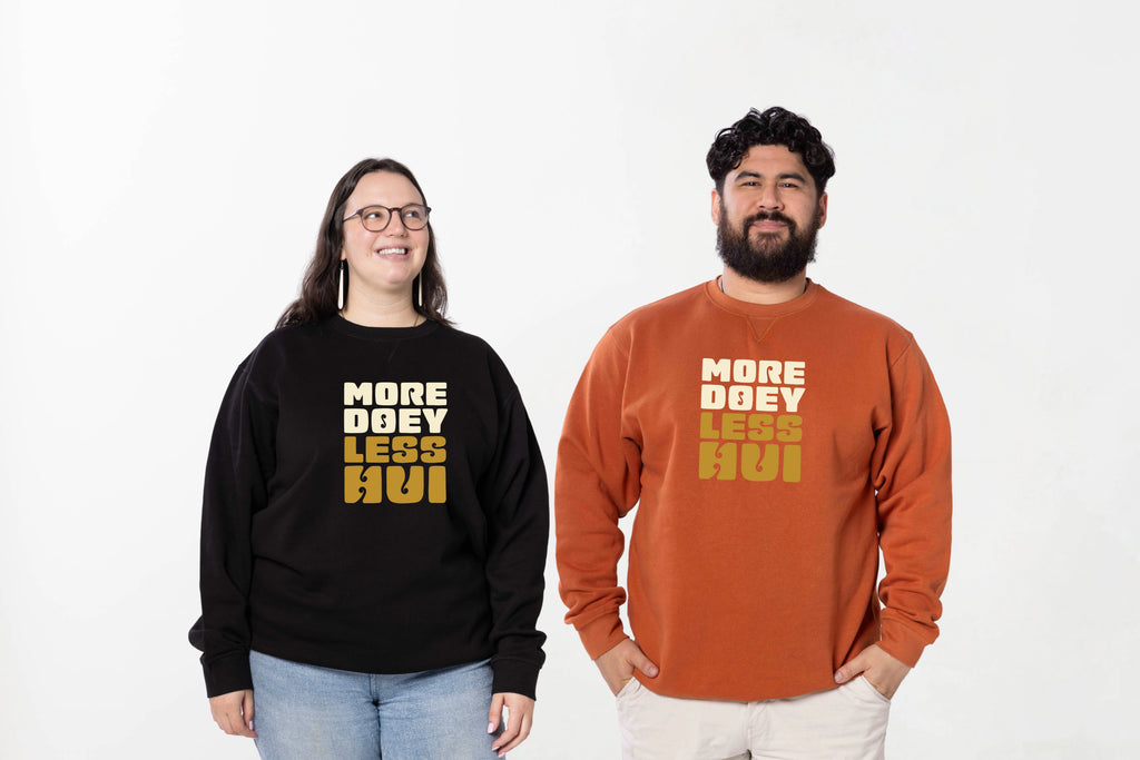 Models wearing the More Doey, Less Hui crewneck – unisex, Māori-inspired cotton/polyester hoodie for everyday NZ wear.